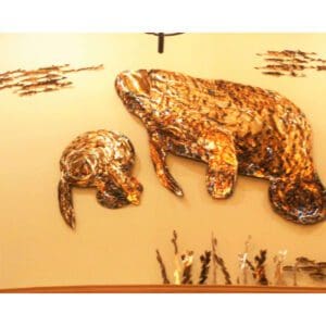 A bear and cub are depicted in this metal work.