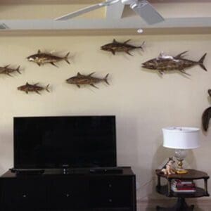 A living room with fish on the wall and a tv