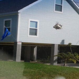 A house with a blue flag flying in the air.