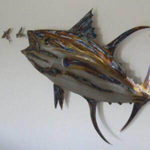 A fish is hanging on the wall with other fish.