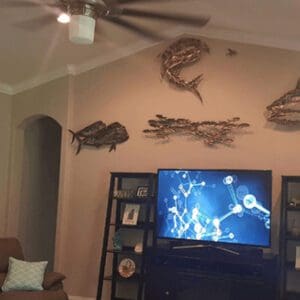 A living room with a tv and some fish on the wall